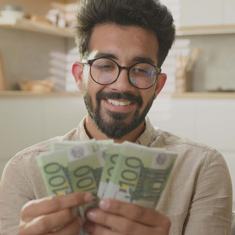 A seller happily counting cash payments